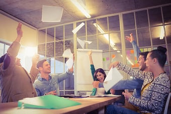  Group of business people celebrating by throwing their business papers in the air 
