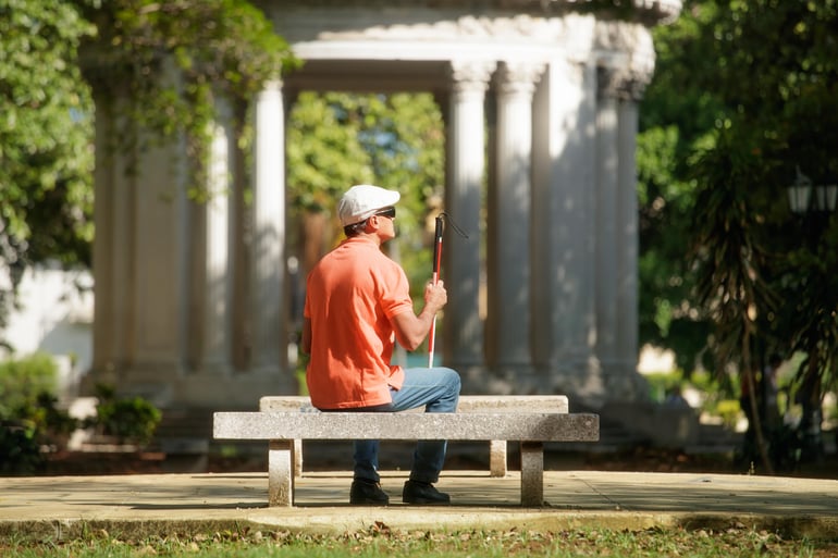 blind-man-sitting-in-city-park-and-resting-PKZJ3FV-min (1)