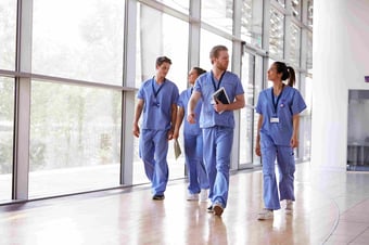 Male and female healthcare workers walk together