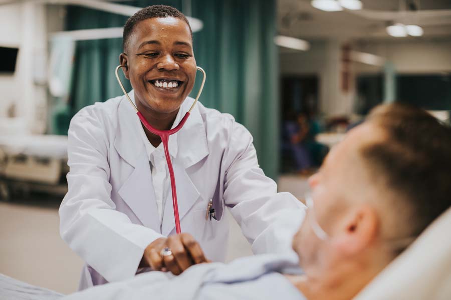 doctor-doing-a-checkup-on-a-hospitalized-patient-6XDGW24