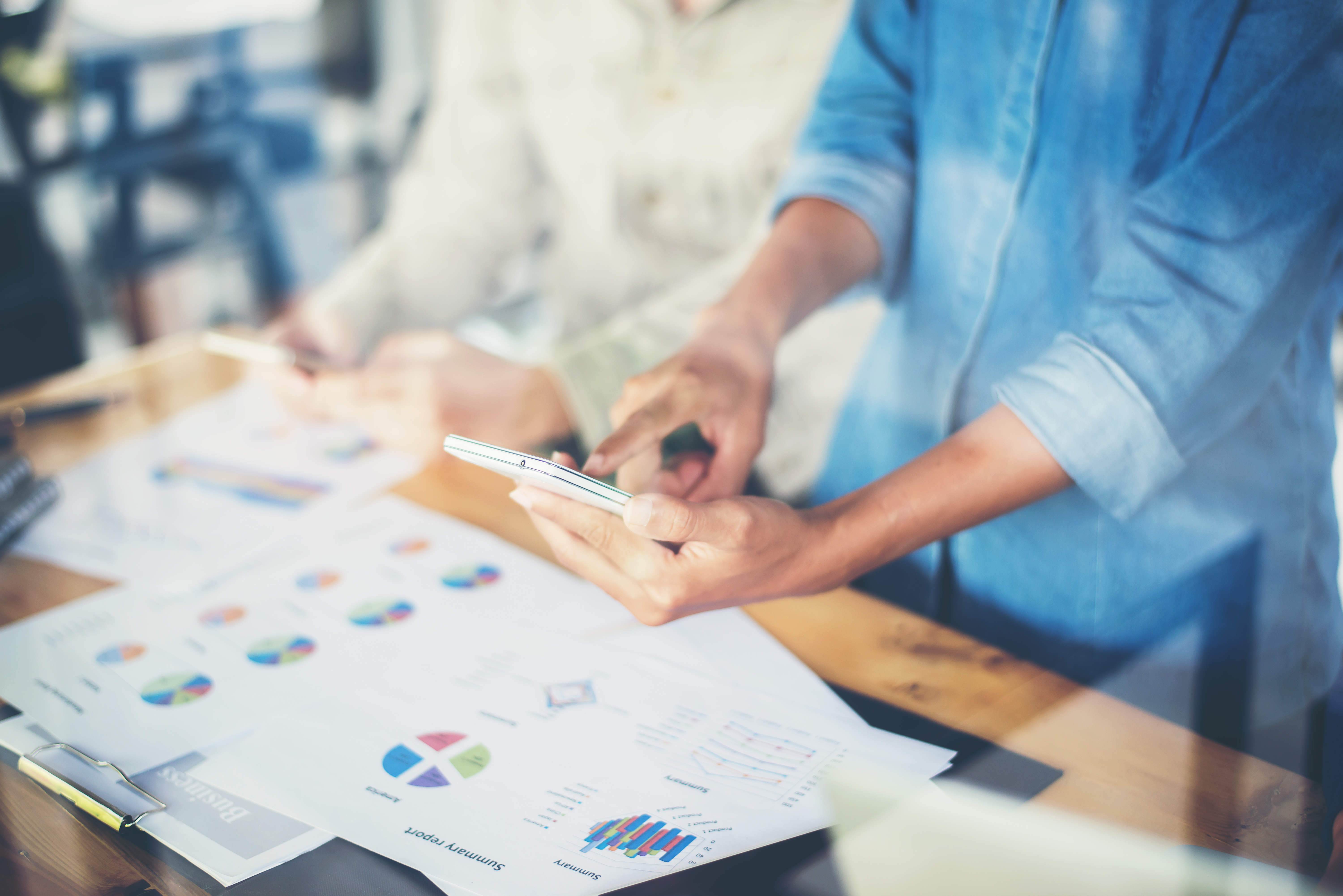 Woman using phone and graph to market