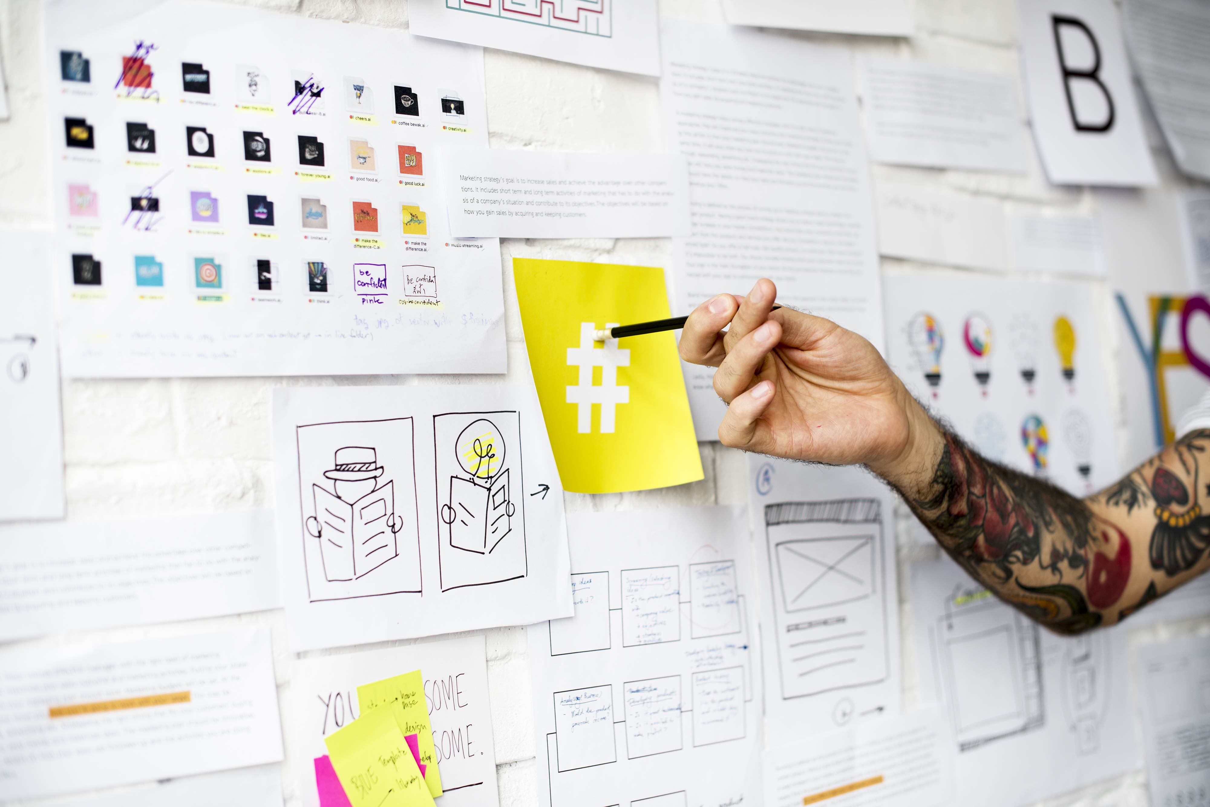 tattoo-hand-pointing-on-hashtag-sign-on-yellow-PB8TYRZ